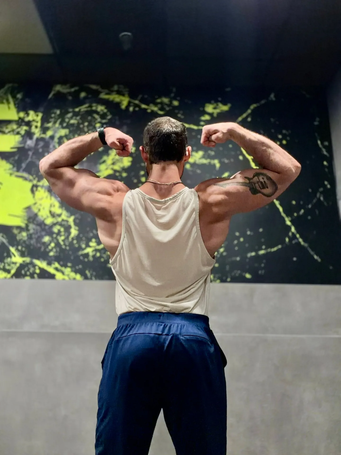 Coach showing rear double biceps pose